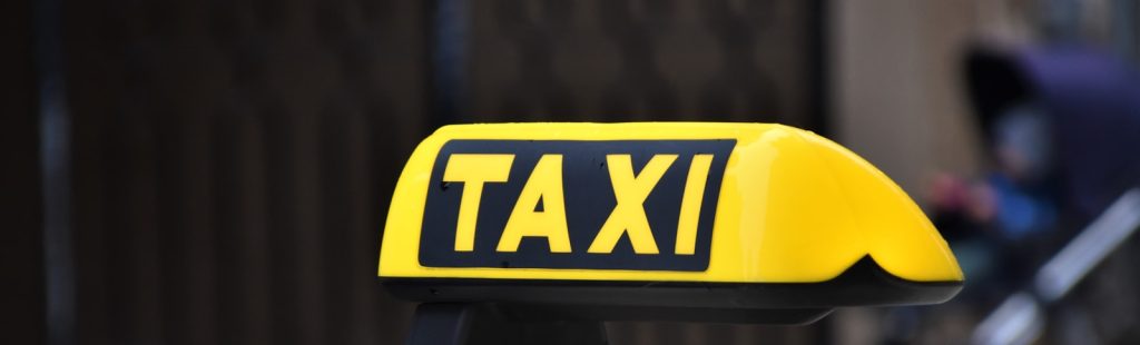 yellow and black taxi sign